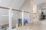 The balcony overlooks the kitchen, dining, and living room